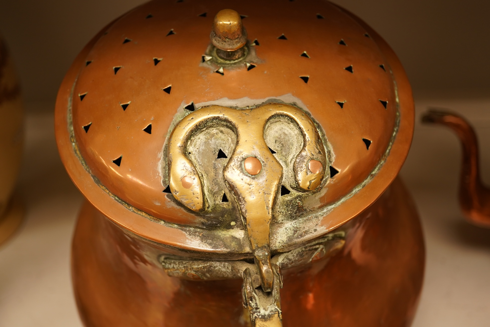 Four various copper vessels and a brass teapot, tallest 47cm